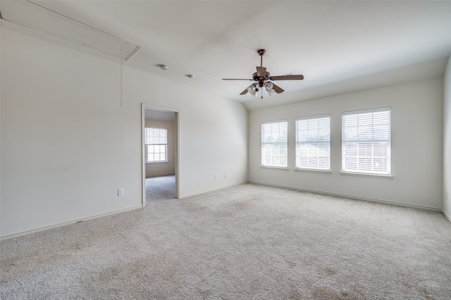 spare room featuring light carpet and ceiling fan