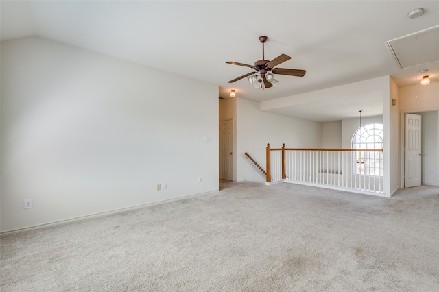 carpeted empty room featuring vaulted ceiling and ceiling fan