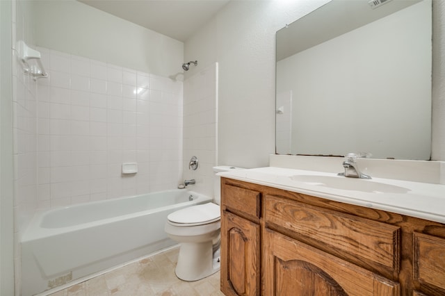 full bathroom with tiled shower / bath, vanity, and toilet