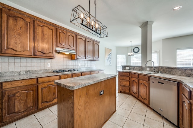 kitchen with a healthy amount of sunlight, sink, a chandelier, and stainless steel appliances