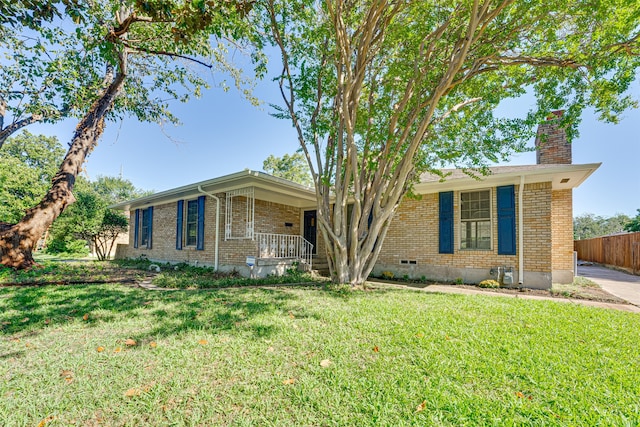 ranch-style home with a front lawn