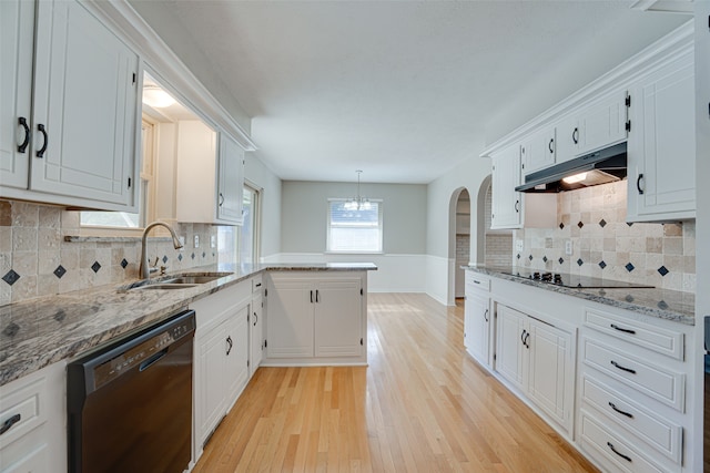 kitchen featuring pendant lighting, light wood-type flooring, sink, white cabinetry, and black appliances