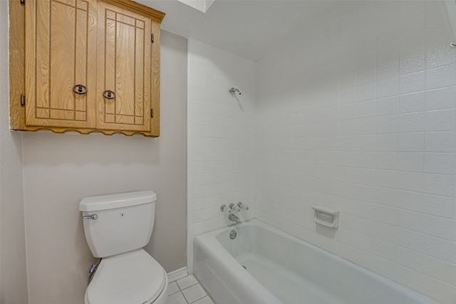 bathroom with tiled shower / bath, toilet, and tile patterned floors