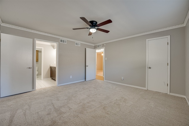 unfurnished bedroom featuring ceiling fan, ornamental molding, ensuite bath, and light carpet