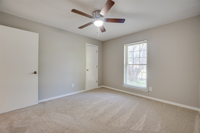 unfurnished room featuring ceiling fan and light colored carpet