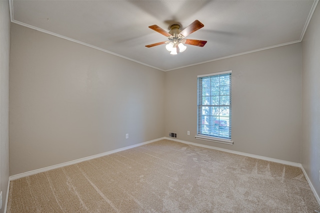 empty room with crown molding, light carpet, and ceiling fan