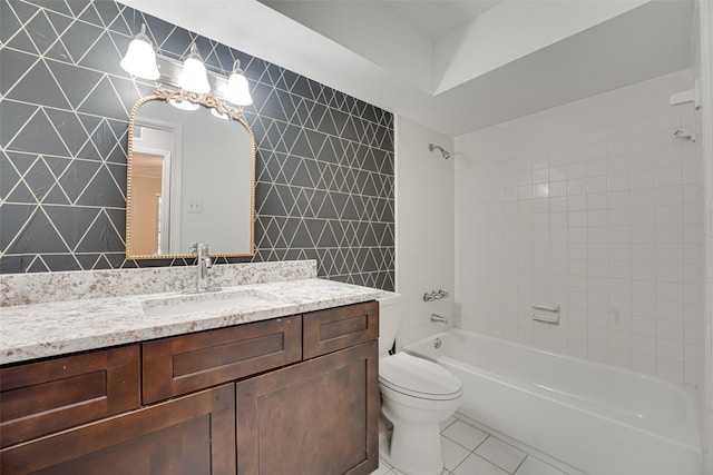 full bathroom featuring tile walls, tile patterned flooring, vanity, tiled shower / bath, and toilet