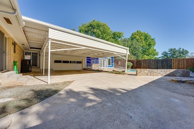 view of vehicle parking featuring a carport and a garage