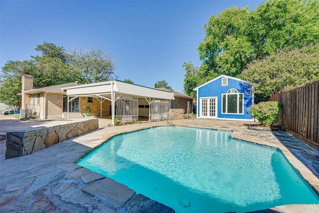 view of swimming pool featuring an outdoor structure and a patio area