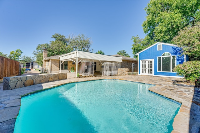 view of pool featuring a patio and an outdoor structure