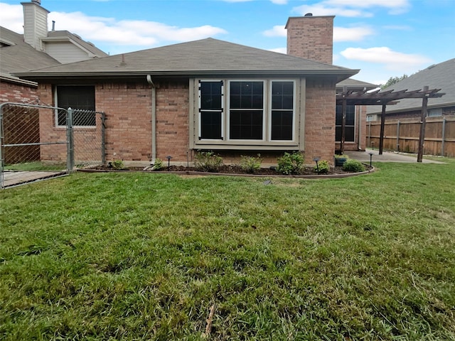 rear view of property featuring a lawn and a pergola