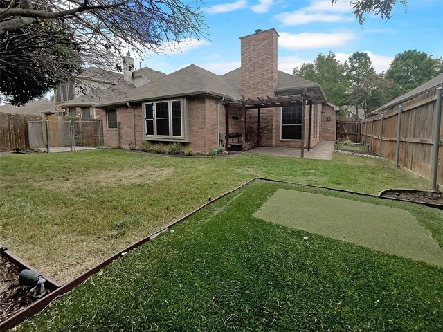 back of house featuring a lawn and a patio