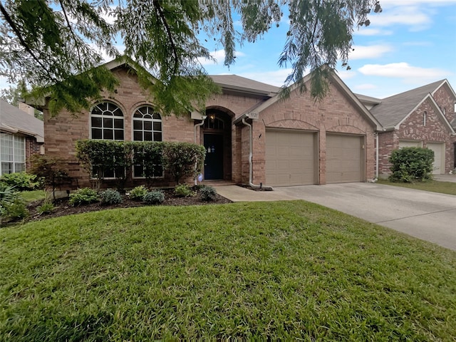 ranch-style home with a front yard and a garage