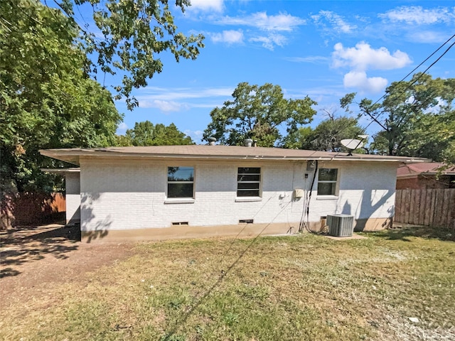 back of property featuring cooling unit and a yard