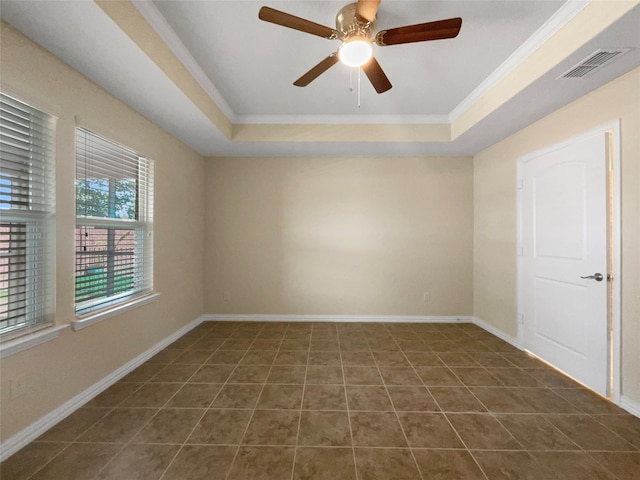 tiled spare room with ceiling fan, a raised ceiling, and crown molding