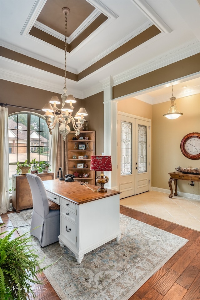 dining area featuring an inviting chandelier, a tray ceiling, light wood-type flooring, french doors, and crown molding