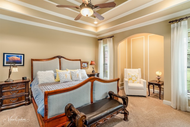 bedroom with ceiling fan, crown molding, a raised ceiling, and carpet floors