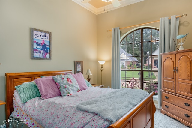 carpeted bedroom with ceiling fan and crown molding