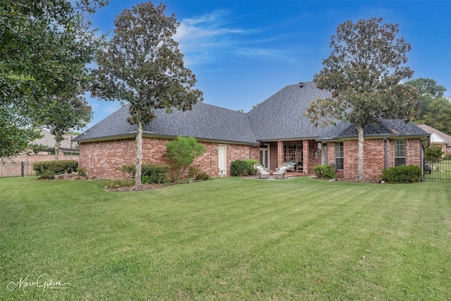 single story home with a patio area and a front yard