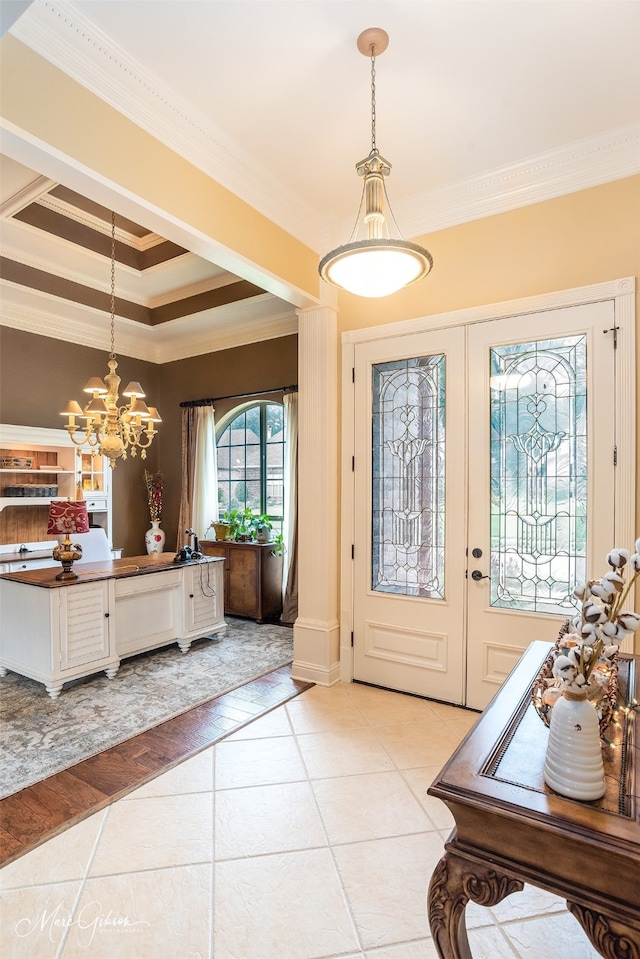 foyer featuring light tile patterned floors, a tray ceiling, crown molding, and a chandelier