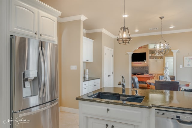 kitchen featuring decorative light fixtures, sink, white cabinetry, appliances with stainless steel finishes, and light tile patterned floors