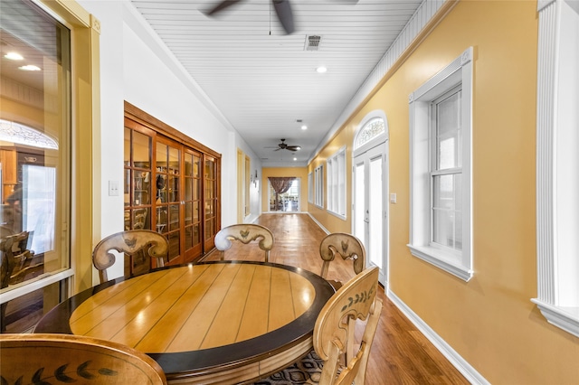 dining area featuring ceiling fan, french doors, wooden ceiling, crown molding, and hardwood / wood-style flooring