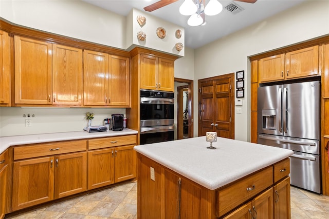 kitchen with ceiling fan, a center island, and appliances with stainless steel finishes