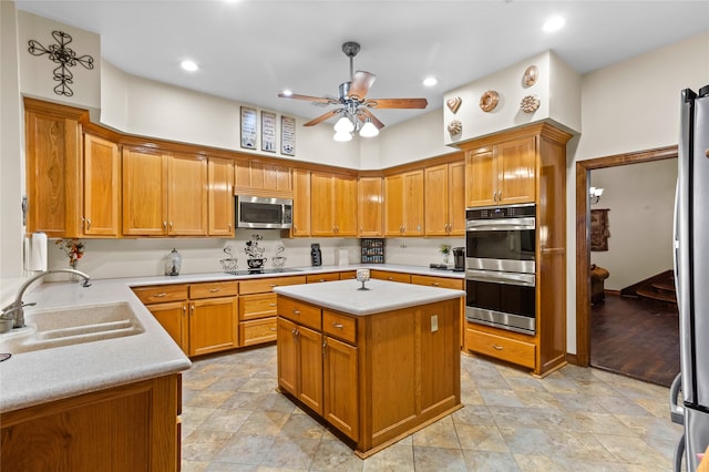 kitchen featuring ceiling fan, a kitchen island, sink, and appliances with stainless steel finishes