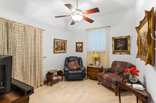 living area featuring ceiling fan