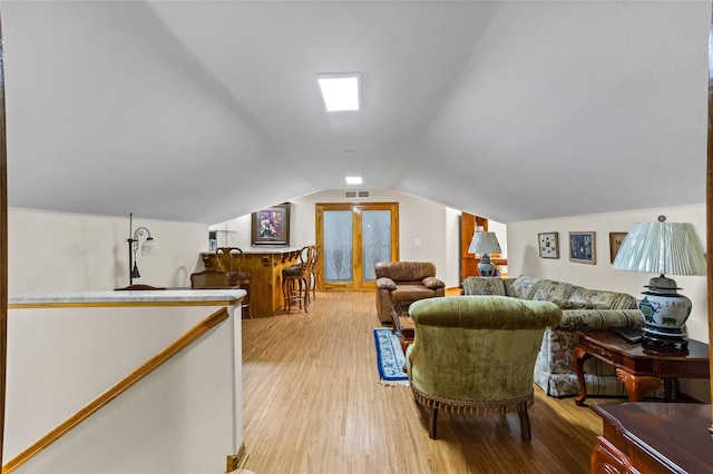 living room featuring light hardwood / wood-style flooring and lofted ceiling