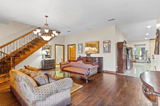 living room featuring dark hardwood / wood-style floors and an inviting chandelier