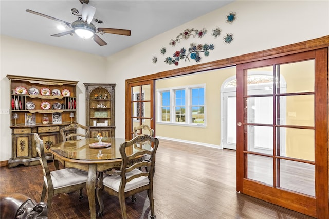 dining room with ceiling fan, wood-type flooring, and french doors