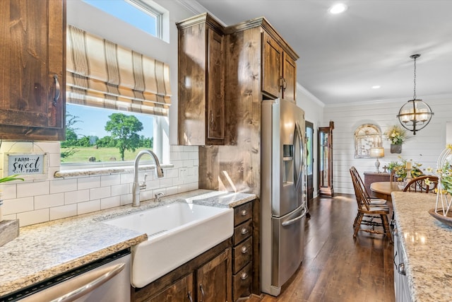 kitchen featuring stainless steel appliances, decorative light fixtures, dark hardwood / wood-style floors, a chandelier, and sink