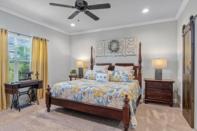 carpeted bedroom featuring a barn door, crown molding, and ceiling fan