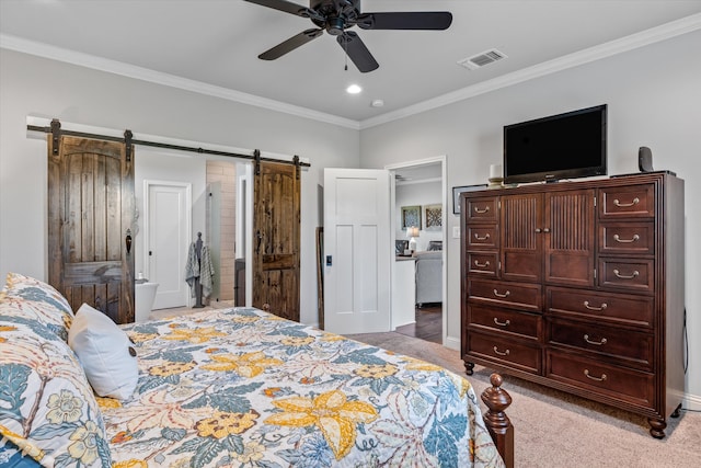 bedroom with a barn door, crown molding, carpet flooring, and ceiling fan