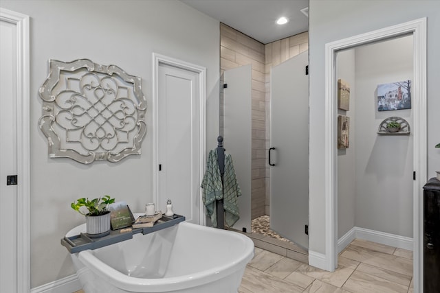 bathroom featuring independent shower and bath