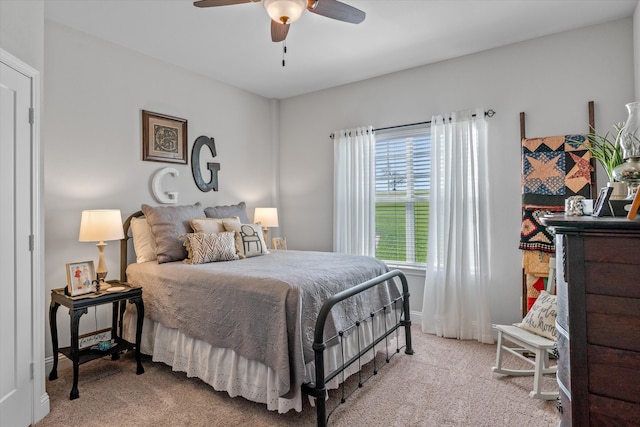 bedroom with ceiling fan and light carpet