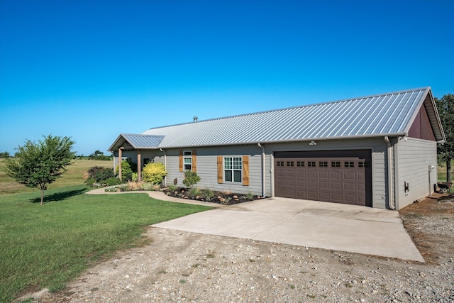 ranch-style home featuring a garage and a front lawn