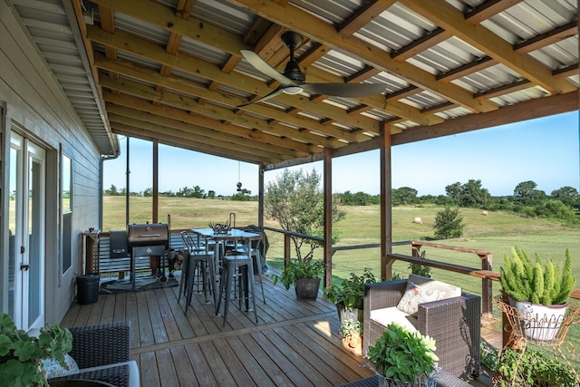 deck with ceiling fan and a rural view