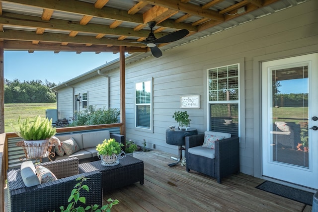 wooden deck with an outdoor hangout area and ceiling fan