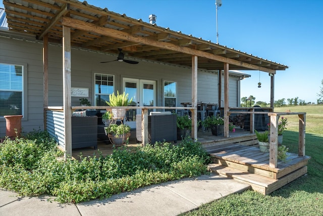 exterior space with ceiling fan and a yard