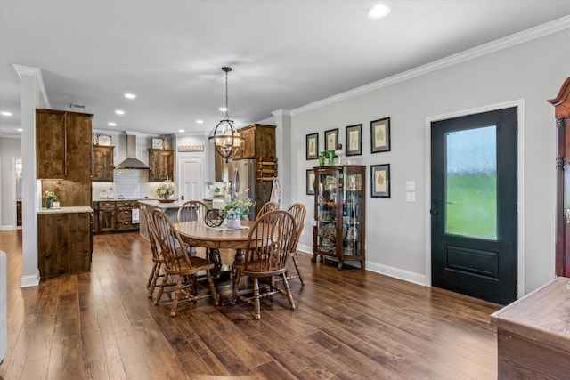 dining room featuring a chandelier, dark hardwood / wood-style floors, and crown molding