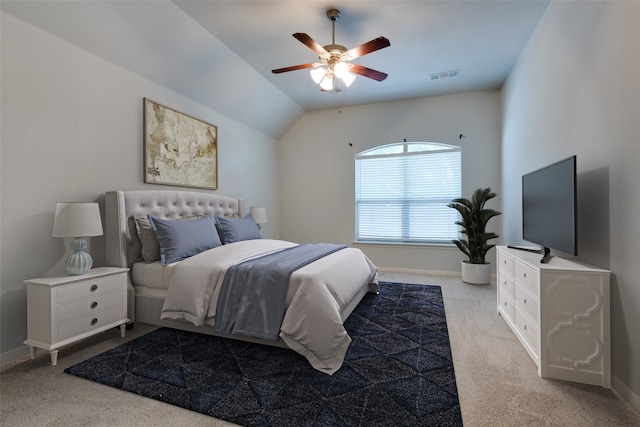 bedroom with ceiling fan, lofted ceiling, and light carpet