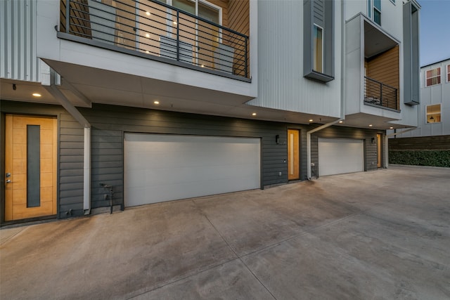 exterior space featuring a balcony and a garage