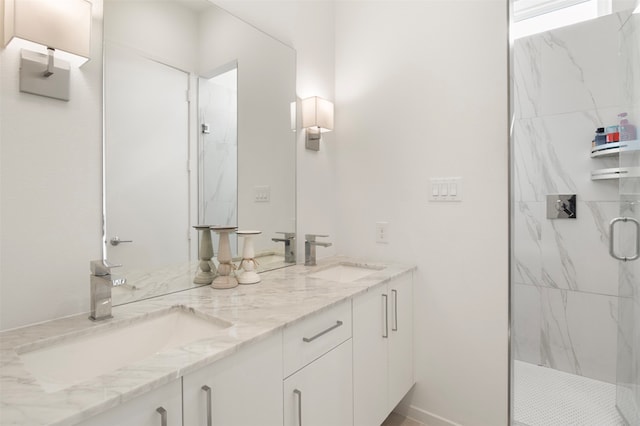 bathroom featuring vanity and a shower with shower door