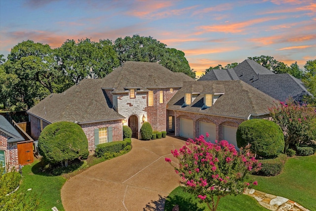 view of front of house featuring a garage and a yard