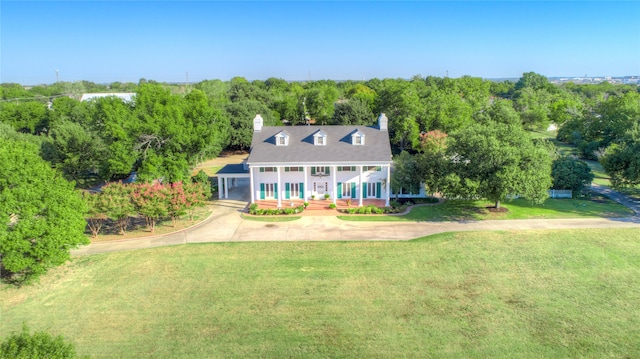 view of front of property with covered porch and a front yard