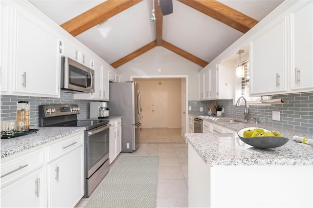 kitchen with stainless steel appliances, light tile patterned floors, decorative light fixtures, white cabinets, and vaulted ceiling with beams