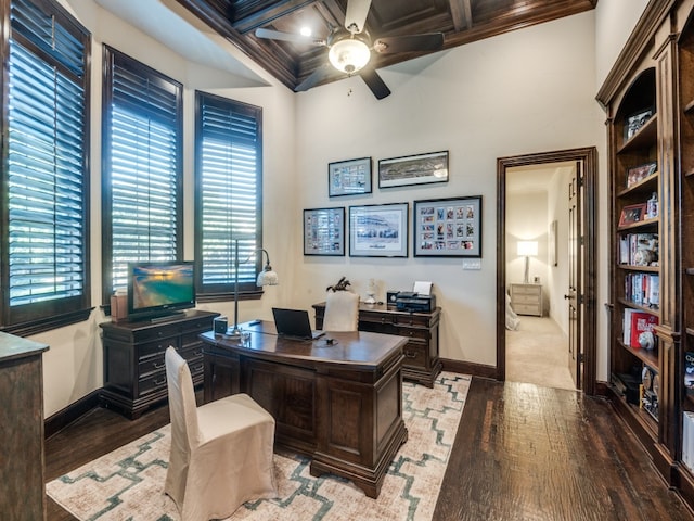 office featuring coffered ceiling, crown molding, wood-type flooring, ceiling fan, and beam ceiling