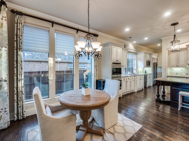 dining space featuring sink, crown molding, and dark hardwood / wood-style floors